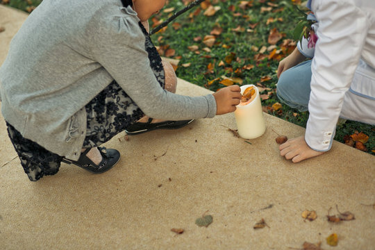 Children is playing with the white candle - Powered by Adobe