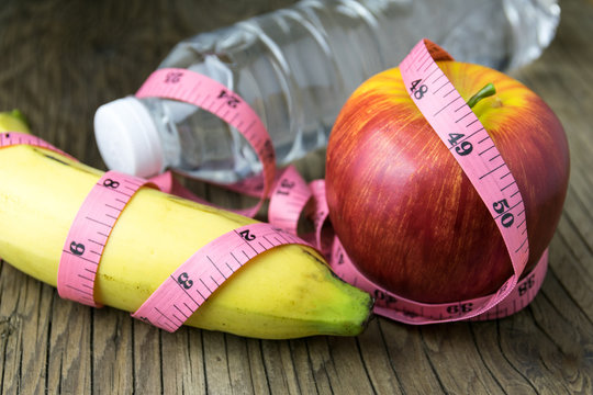 Healthy eating concept, tape measure, fruit and water bottle on