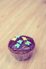 chocolate muffin on wooden ground