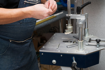 Craftsman working on frame in frameshop.