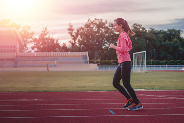 Obraz premium Beautiful woman fitness runner stretching and preparing to run.w