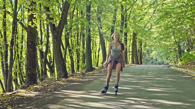 Beautiful woman driving roller skates on sunny day
