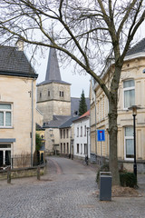 Obraz premium Street with old church tower and old houses in Valkenburg, The Netherlands