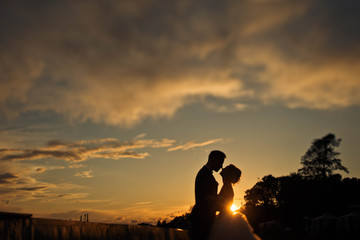 groom and bride  meets a beautiful sunrise