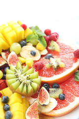 Fresh fruit salad on a white wooden table