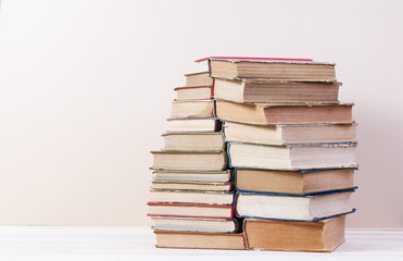 Stack of hardback books on wooden table. Back to school. Copy space