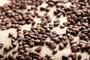 Brown roasted coffee beans on sackcloth
