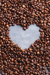 Roasted coffee beans on a grey table