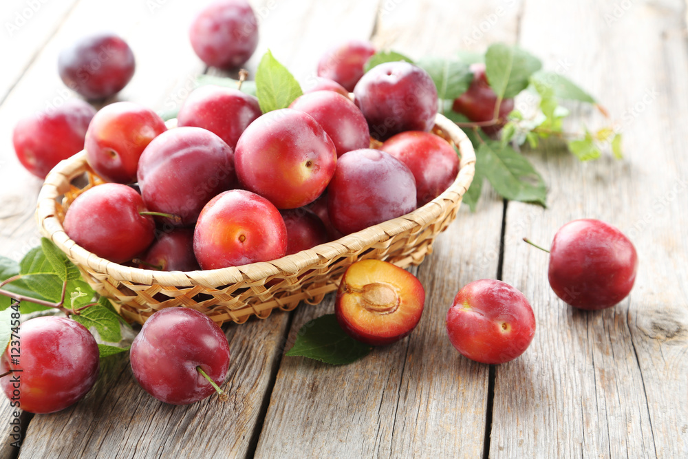 Sticker fresh plums on a grey wooden table