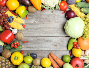 Ripe fruits and vegetables on wooden table