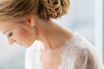 Bride with the hairstyle in the lace robe