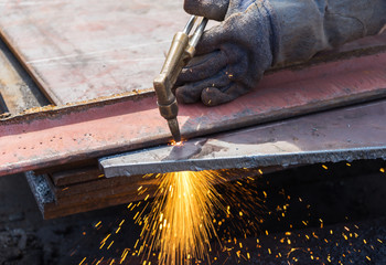 worker cutting steel using metal torch