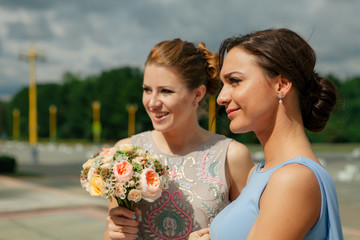 Beautiful smiles of the bridesmaids in the sunny day