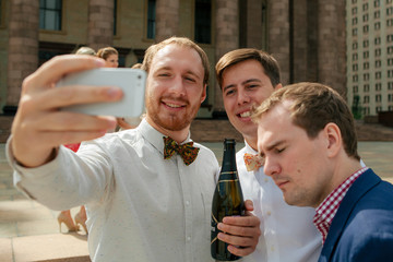Groom with the friends are taking a photo