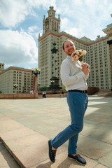 Funny friend of the groom with the wedding bouquet