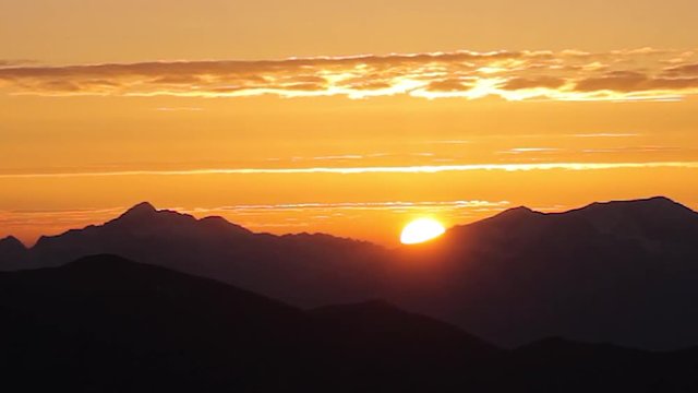 Amazing colorful  sunset  mountain chain. Time lapse sky background. Beautiful fiery sunset wide angle lens