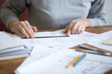 Female hands, working at the desk with a ruler and a drawing. Education concept photo, close-up