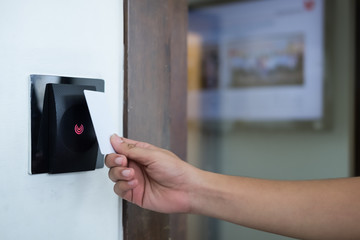 Door access control with a hand inserting key card to lock and u