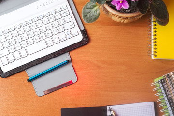 Office desk table with computer, supplies, flower. Copy space for text