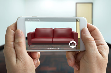 Augmented reality marketing technology concept. Hand holding smart phone use AR application for simulate furniture and interior design products in room home. 3D rendering