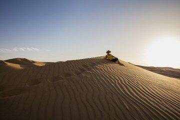 Fototapeta na wymiar Resting on a Rub'al Khali Desert Dune