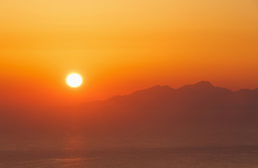 Fototapeta premium sunrise on Santorini behind Anafi island