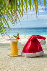 Cocktail "Boots Santa Claus" and the Santa Claus hat on the sand