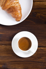 Espresso cup and croissant.