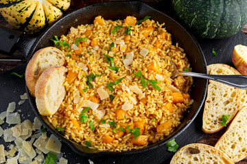 Pumpkin risotto in iron pan with Parmesan cheese. top view