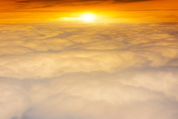 Beautiful sunrise above clouds during a flight