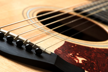 acoustic guitar detail of the bridge and of the saddle