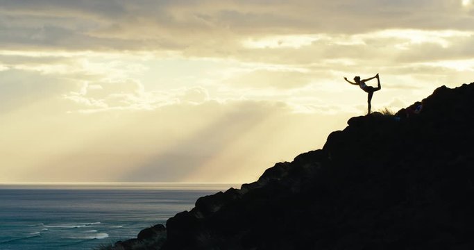 Yoga silhouette of young woman in dancer pose