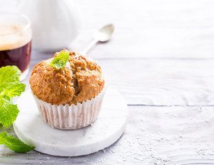 Delicious homemade coconut cinnamon muffin on marble coasters. Healthy food concept with copy space.
