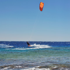 man riding on kite surf board on Red Sea, Dahab