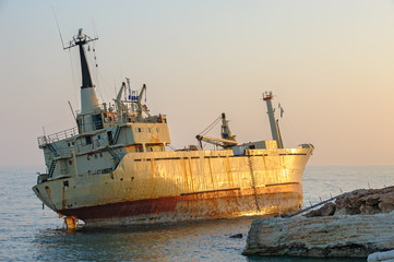 Ship aground near rocky coast
