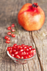 Pomegranate fruit on wooden vintage background.
