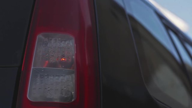 Color close up footage of a car's turn signal blinking.