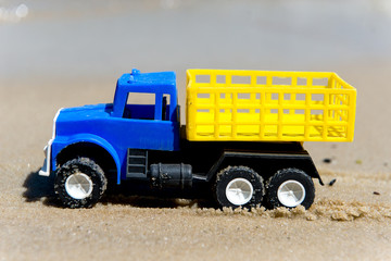 Toy cars on the wet sand. Summer vacation at sea.