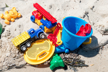 Fototapeta na wymiar Child's toys on sandy beach. Summer holidays concept