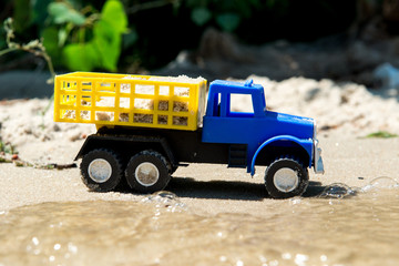 Toy cars on the wet sand. Summer vacation at sea.