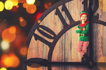 Christmas concept. Little Elf on clockwise