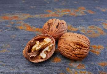 Whole walnuts on slate background