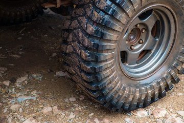Wet off road tire on dirt background