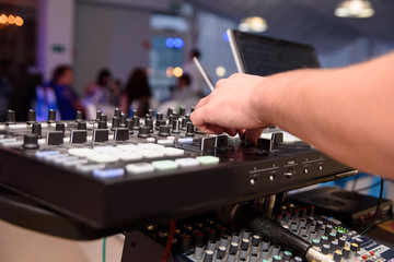 Dj mixes the track in the nightclub at party