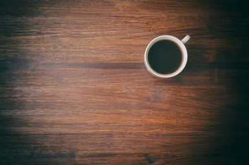 Coffee cup on brown table. Top view
