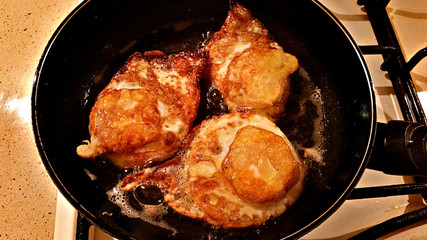 Three eggs fry in olive oil in a frying pan