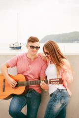Fototapeta na wymiar Happy couple with guitar outdoor
