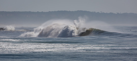 Ocean waves in Costa da Caparica. Autumn day in Almada, Portugal.
