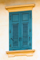 Old wooden shutters on the window in blue.