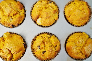 Tray of homemade vegan pumpkin muffins with pears and dried cherries